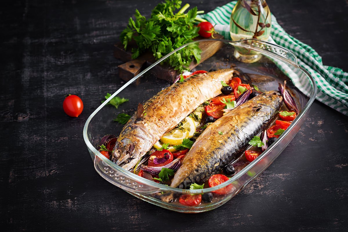 Baked mackerel with herbs and lemon and vegetables. Healthy dinner.