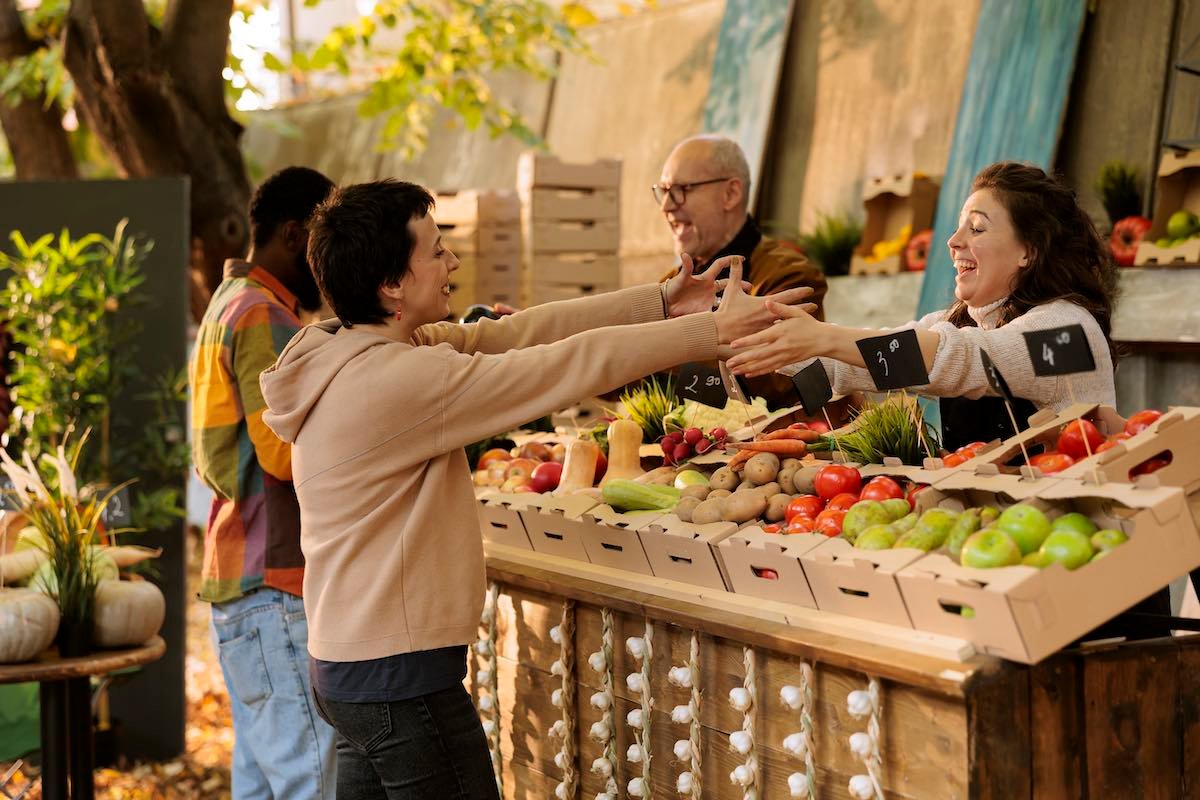 Vendor greets client at farm fair booth